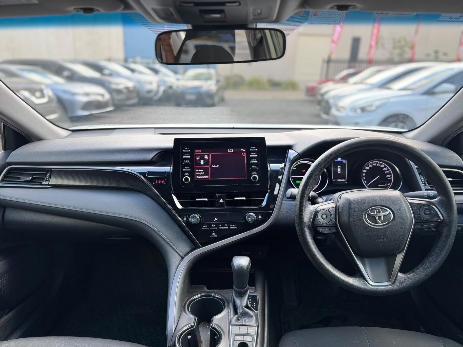 2021 Toyota Camry Hybrid Ascent Sedan in White.