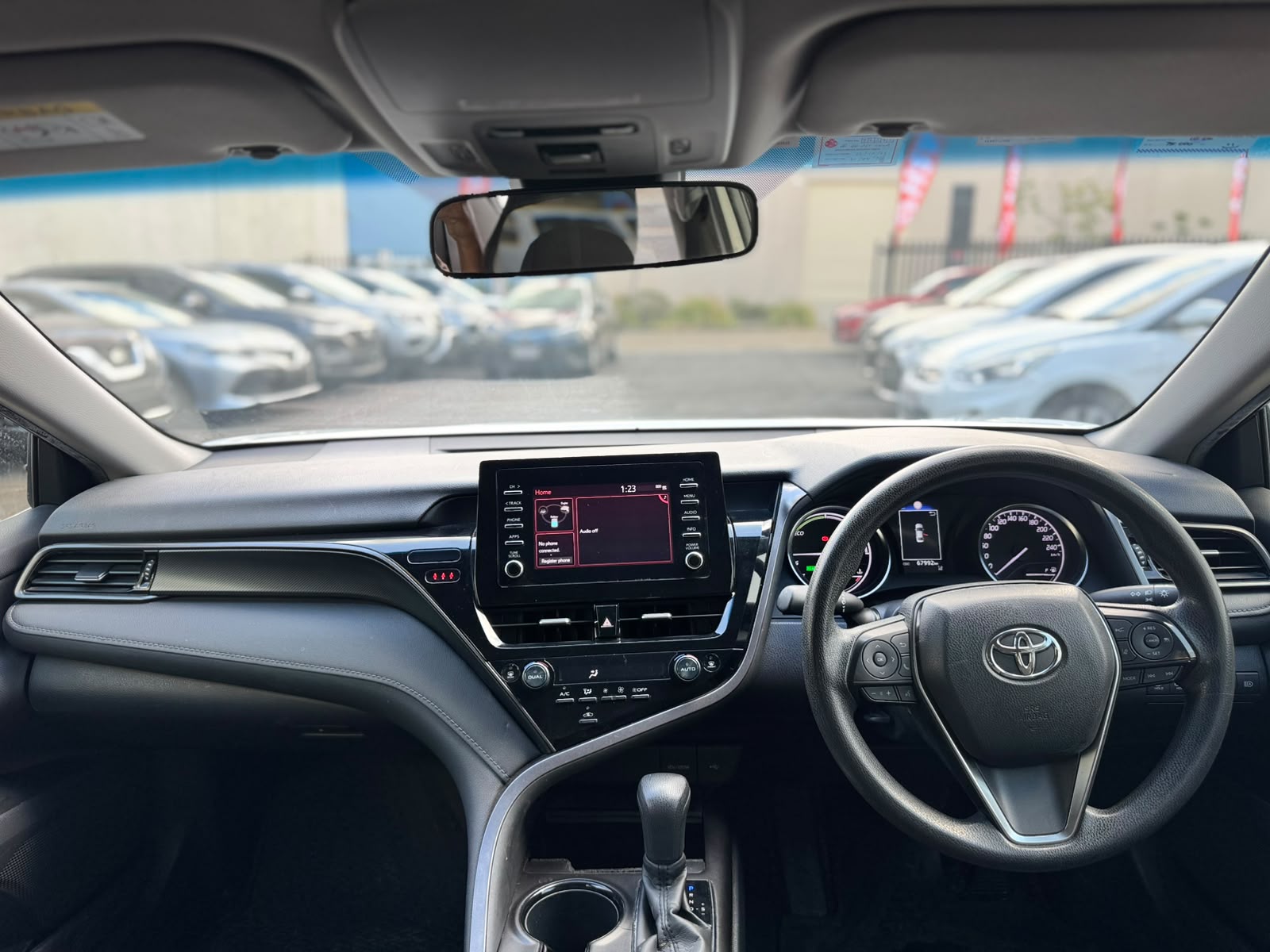 2021 Toyota Camry Hybrid Ascent Sedan in White.